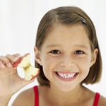 Image of a girl eating an apple.