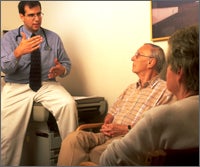 Doctor talking to two older couple