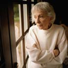 elderly woman looking out window