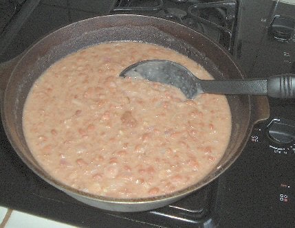 Refried beans being cooked in a pot