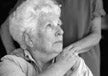  elderly woman with a hand on her shoulder