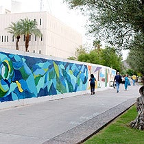 Mural painted by students on a 250 ft. barrier