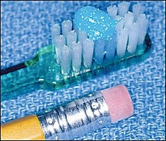 Picture shows the proper amount of fluoridated toothpaste on a toothbrush and a pencil eraser which approximates the size of toothpaste that is necessary.