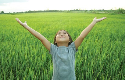 girl raising arms in the air