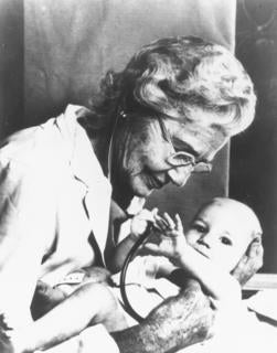 Helen Taussig examining a baby, ca. 1980