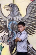 image of boy in front of Mexican eagle