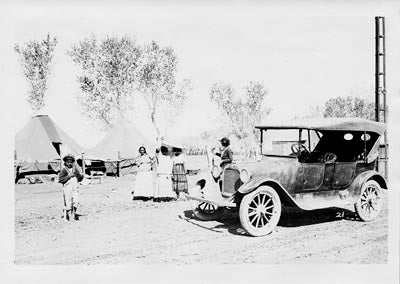 Principal Lynd, visiting with migrant farm workers, 1920