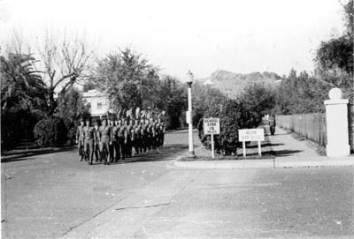 Soldiers marching south on College Avenue, 1940s