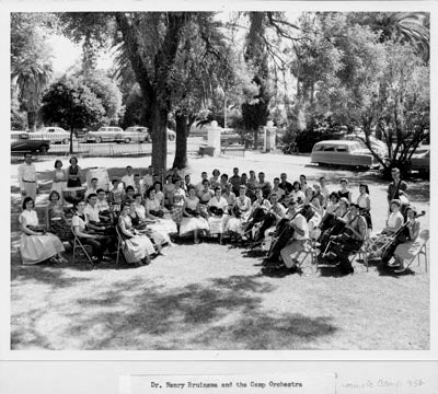 Henry Bruinsma, 
Founding Dean of the College of Fine Arts, with 
Music Camp Orchestra on the lawn of Old Main, 1956