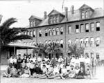 Class portrait showing Old Main and the original Normal School Building, 1901