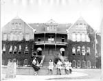 Students sitting by the fountain in front of Old Main, 1940