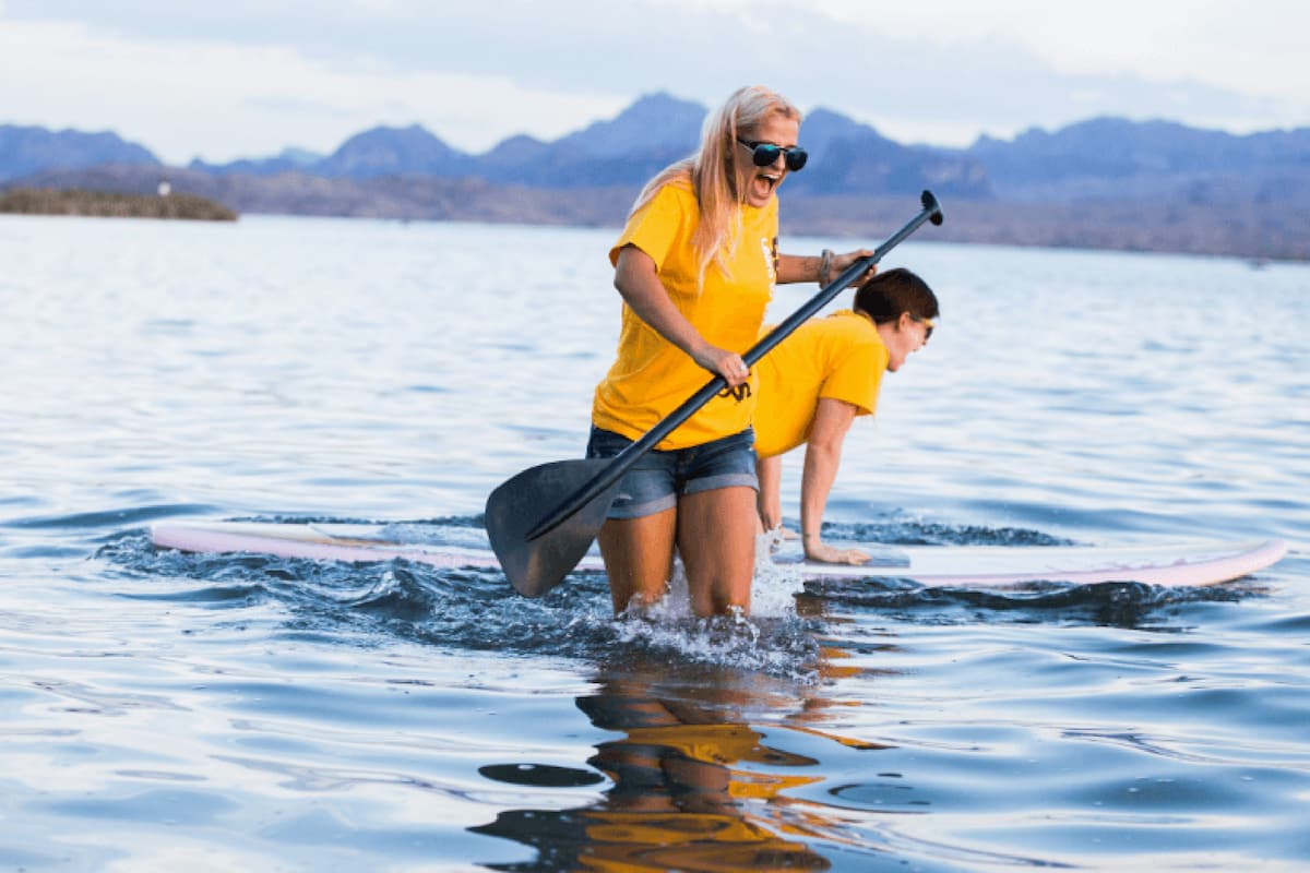two persons enjoying near lake