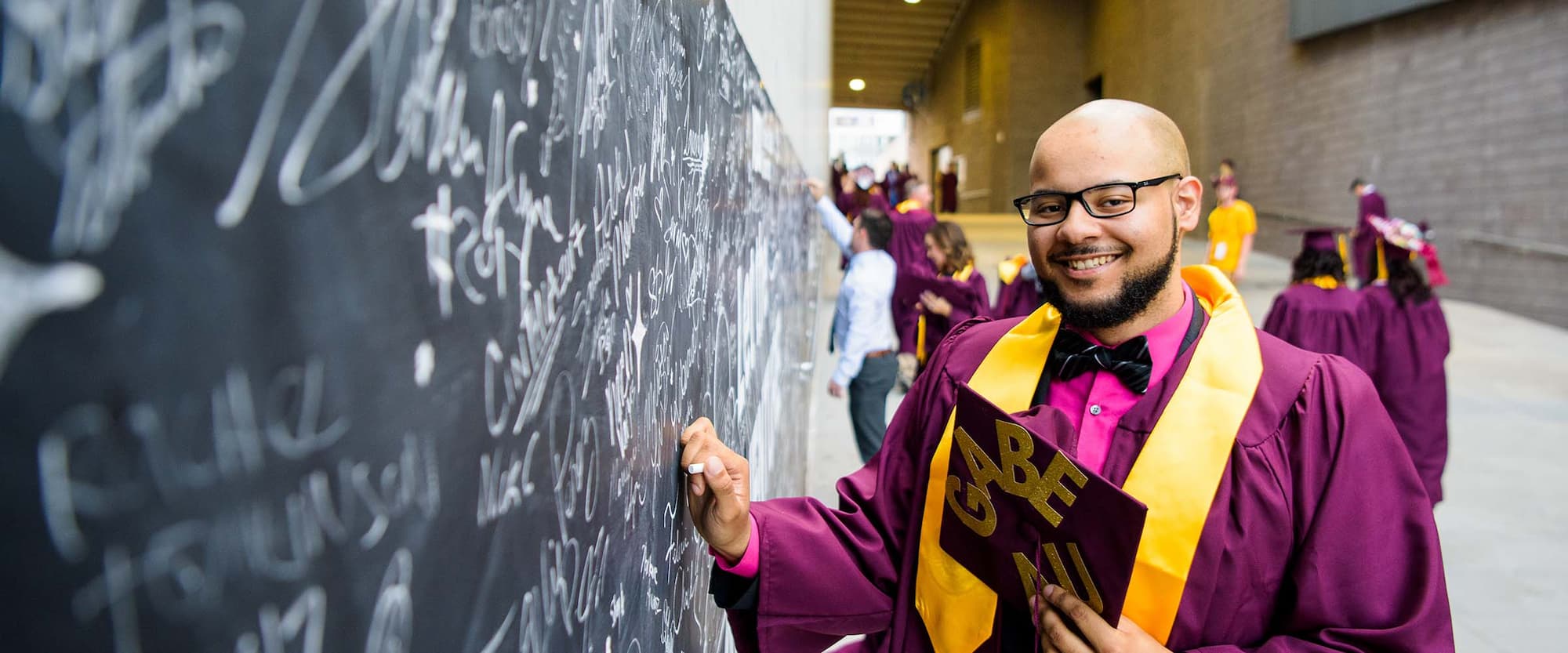 person in ASU graduation gown 