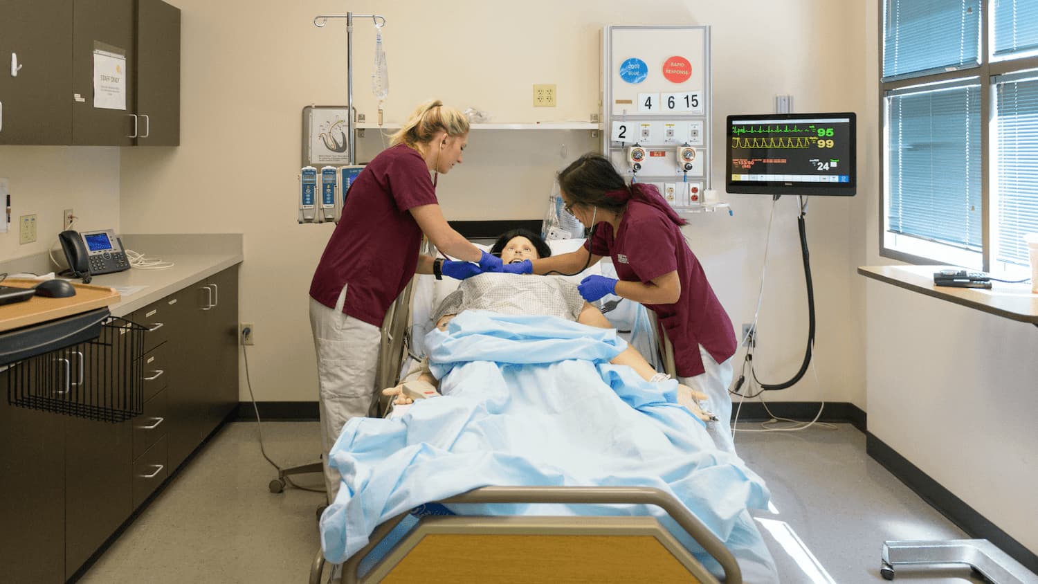 Nursing students practicing on a artificial patient