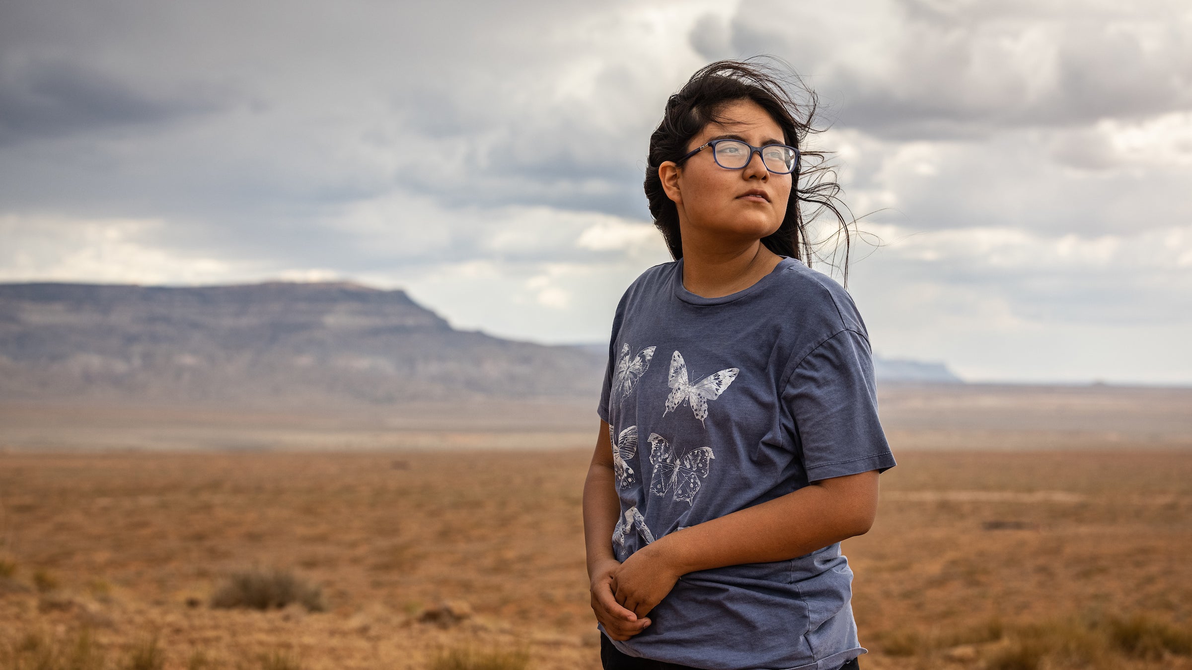 Teenage girl on Navajo reservation, looking up at sky