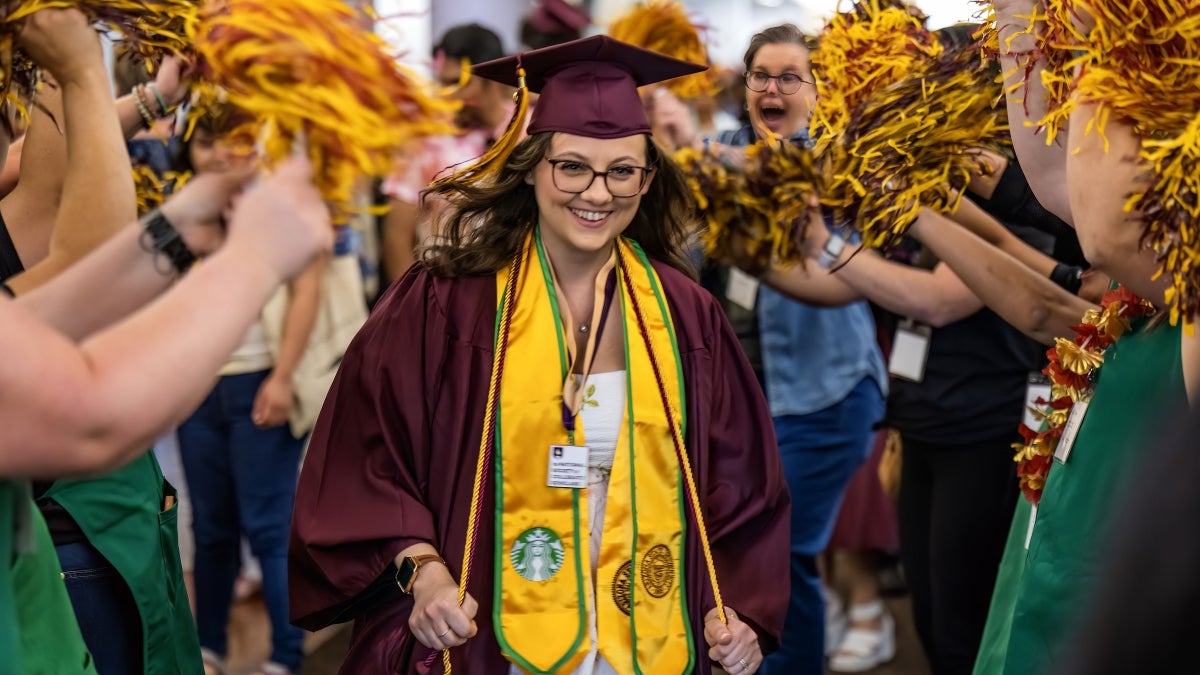 Student at commencement with Starbucks sash on