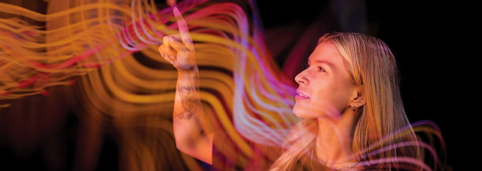 girl touching digital streaks