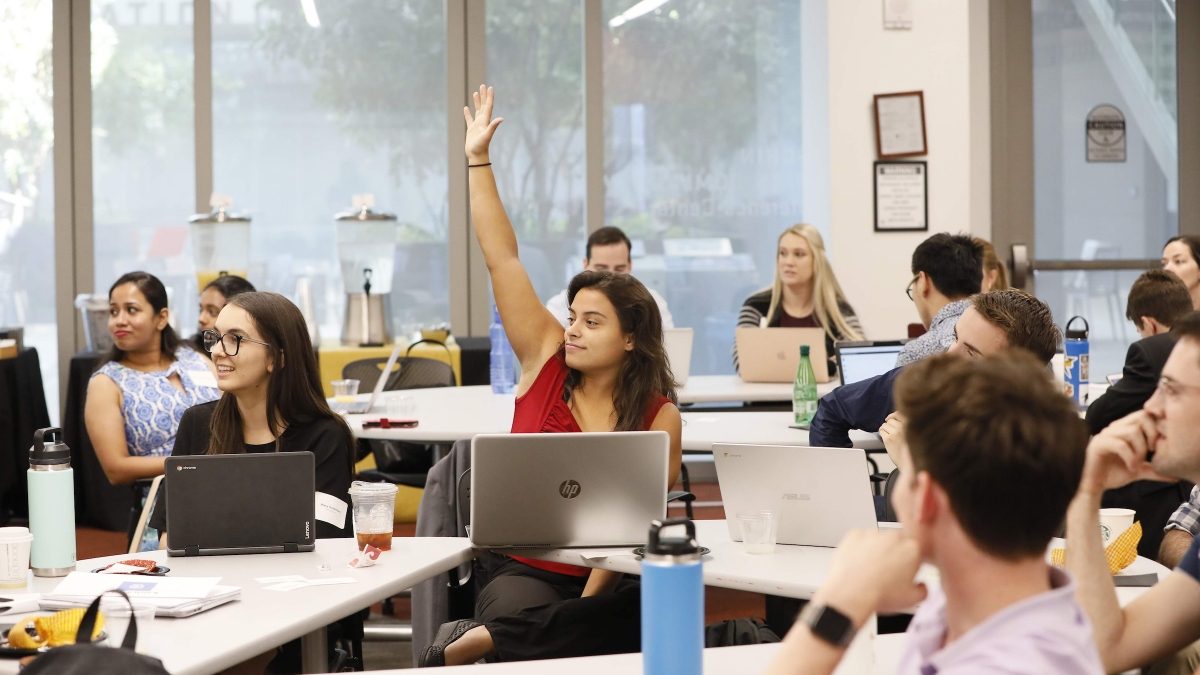 Student raising their hand in class.