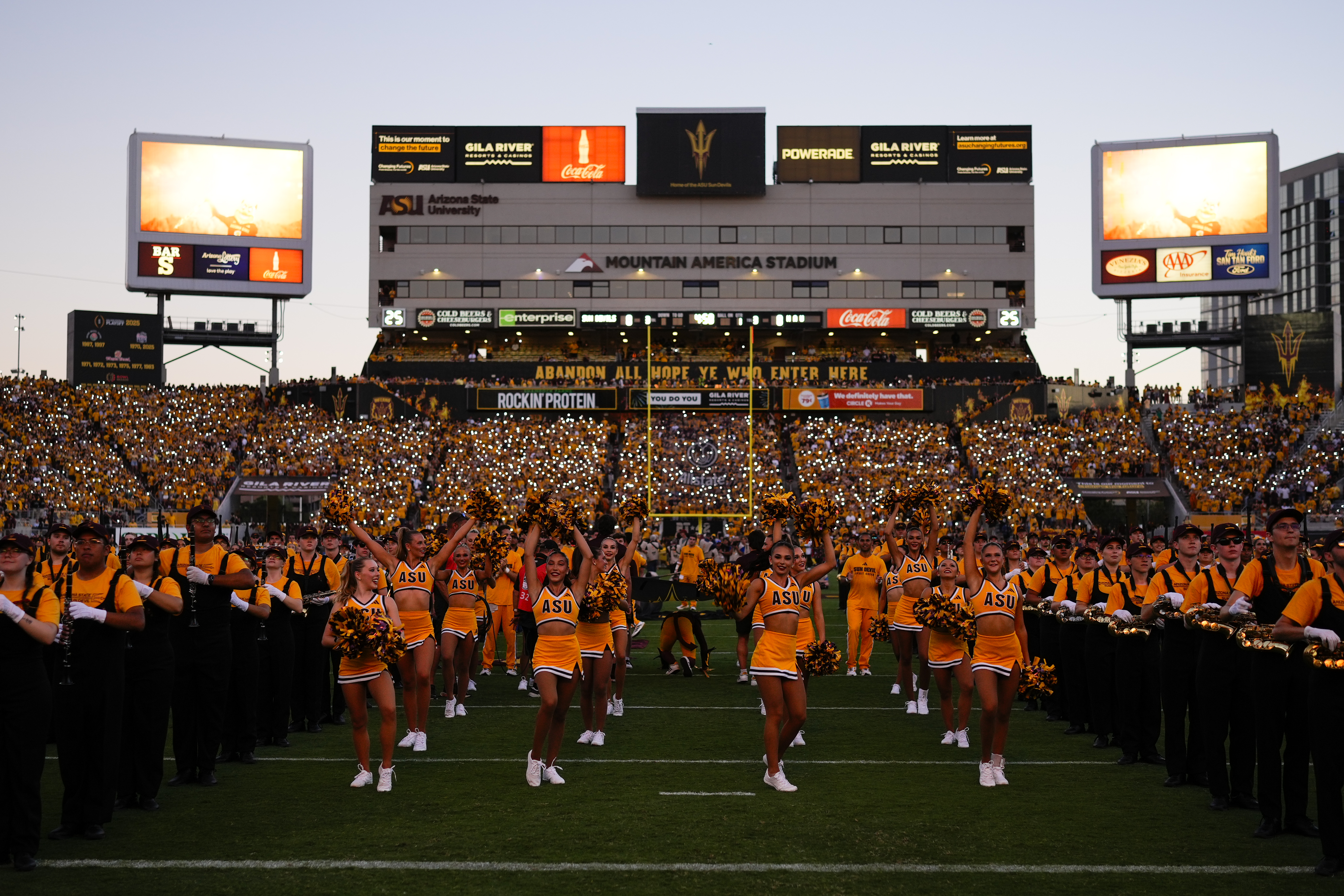 Mountain America Stadium at sunset with Spirit Squad and Marching band on the field before a game