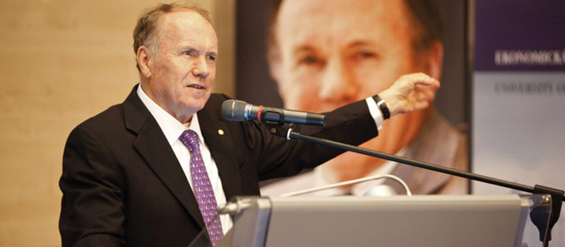 Edward Prescott at speaking behind a podium.