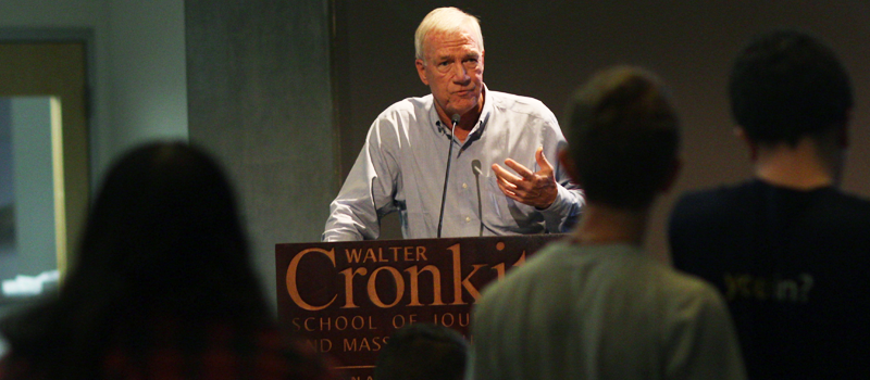 Walter Robinson speaking at a podium.