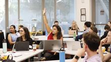 Student raising their hand in class.